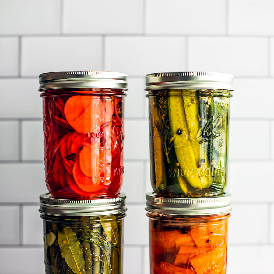 Colorful array of pickling jars filled with various pickled vegetables