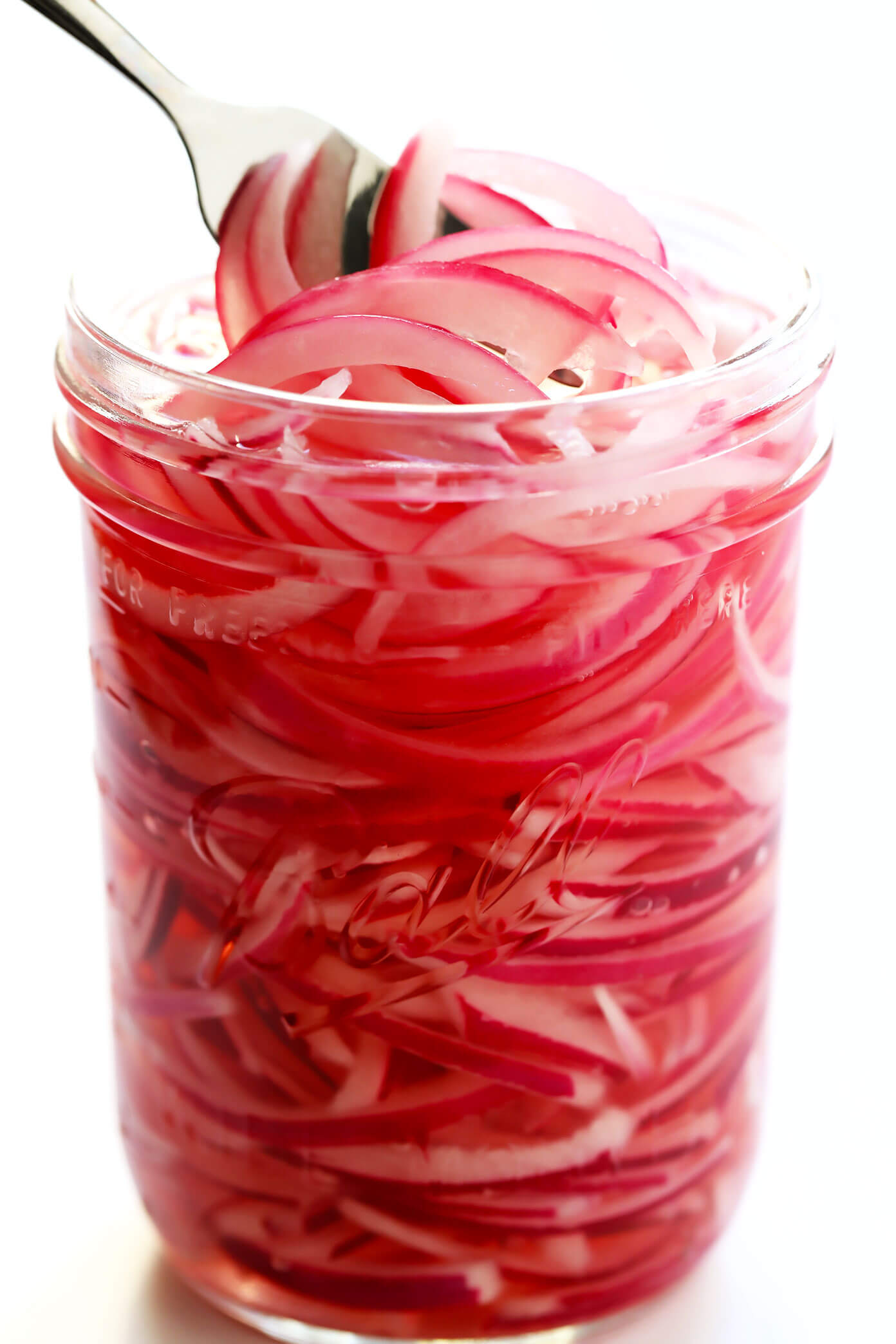 Jar of vibrant pickled red onions